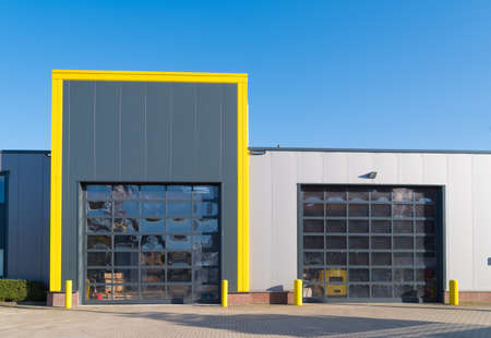 modern industrial unit with roller doorsの写真素材