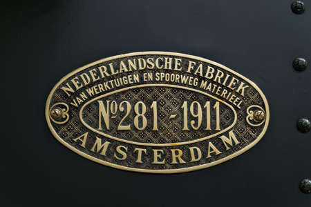 UTRECHT, NETHERLANDS - AUGUST 13, 2019: old emblem saying "Dutch factory of tools and railway material" in the Railway Station in Utrechtのeditorial素材