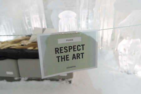 JUKKASJAVI, LAPLAND - FEBRUARY 24, 2020: Sign asking to respect the art in the official Ice Hotel in the north of sweden.のeditorial素材
