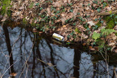 empty beer can dropped in a ditch