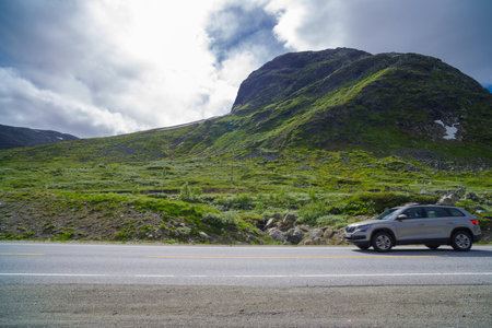 car on scenic rv52 road through the norwegian mountains.の写真素材