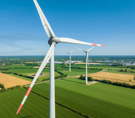 three wind turbines in an agricultural landscape seen from the airの写真素材