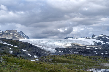 beautiful norwegian landscape with hills and a lake in frontの写真素材
