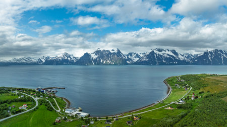 aerial view of some snowy mountains and a lake in Norway.