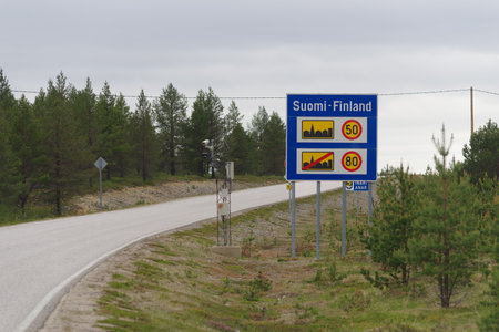 Border sign on the border between Finland and Norway indicating speed limitsの写真素材