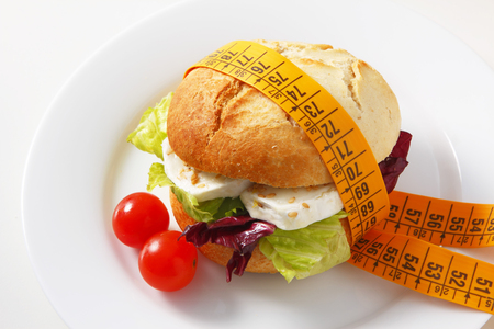 A delicious bun filled with mixed salad and goat cheese with sesame seeds.のeditorial素材