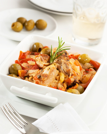 Chicken with tomato, bell pepper, onion and olivesの写真素材