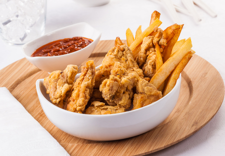 Homemade Kentucky style fried chicken nuggets with french fries and ketchup.の写真素材