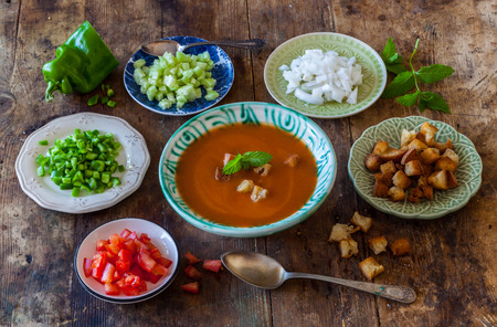 Spanish Cuisine. Gazpacho. Andalusian cold soup served the authentic way with garnishes served separately. Rustic retro vintage ambiance.の写真素材