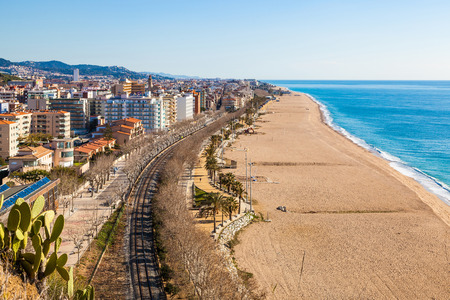 CALELLA, BARCELONA, SPAIN - FEB 19, 2016. View over the touristic town and beach of Calella, Costa Brava, on the Mediterranean coast. The beach of Calella is more than 2 km long and is popular in the summer months with locals and tourists.の写真素材