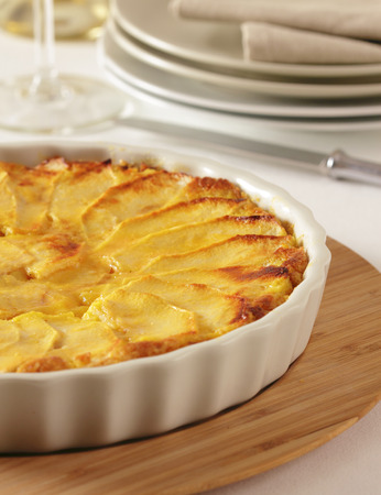 A homemade apple pie in a tray with slices of apple on top.の写真素材