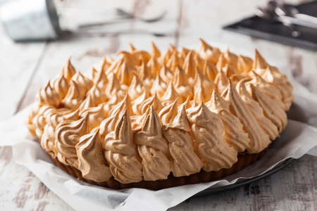 A delicious meringue pie on a wooden tableの写真素材