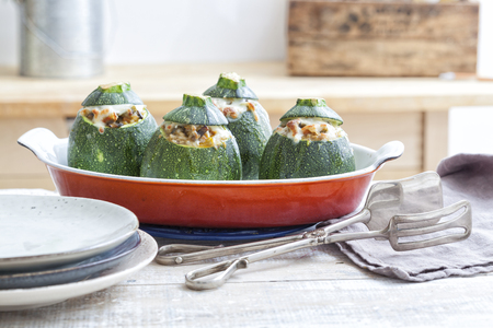 Stuffed oven baked round zucchini on an oven dish.の写真素材
