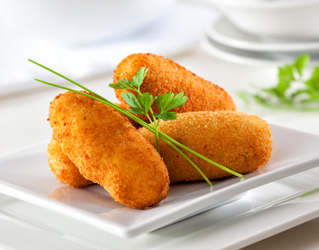 Delicious homemade gourmet croquettes on white plate.の写真素材