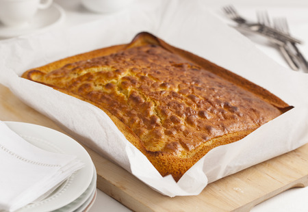 Homemade cake in baking paper on a cutting board