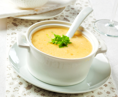 Vegetarian cream soup in a ceramic bowl with spoon.の写真素材