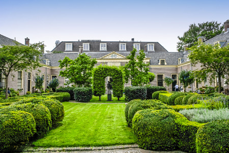 HAARLEM, NETHERLANDS - AUGUST 3, 2011: Green courtyard surrounded by old houses in Hofje van Oorschot in the city of Haarlem, Netherlandsのeditorial素材