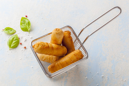 Latin-American appetizers called Tequenos made of fried corn filled with cheese.