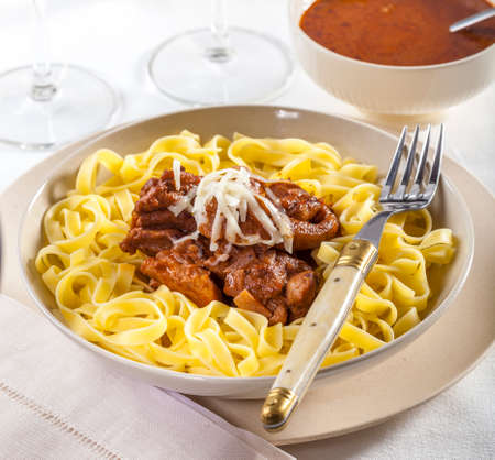 Delicious dish of chicken served with tagliatelle pastaの写真素材