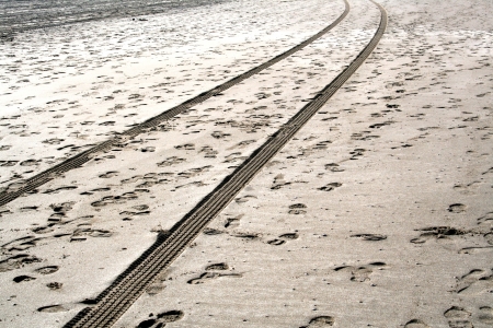 Tire and footprints on the beachの写真素材
