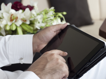 Saudi Arabian VIP Hands Holding and Using Tabletの写真素材