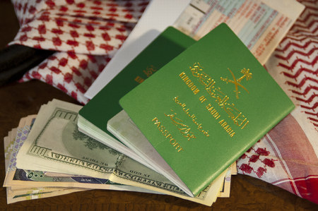 Saudi Document Passport, Flight Ticket, Saudi Riyals Money and American Dollars with Shumagh Head Coverの写真素材