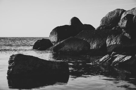 A black and white picture of rocks in the waterの写真素材