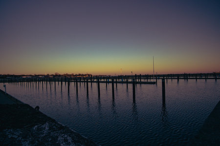 Empty piers in a port. The sun is going down in the backgroundの写真素材