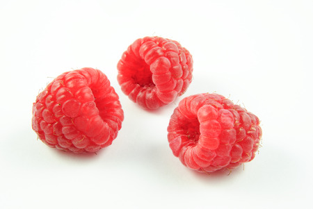 three raspberries (Rubus idaeus) on white backgroundの写真素材