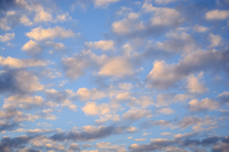 white, pink and gray clouds in autumn evening sky just before sunsetの写真素材