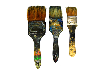 Three dirty paint brushes be stained with color isolated on white background. Art colorful paint brush.の写真素材