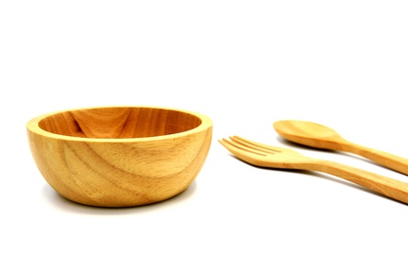 Wooden bowl and blurred wooden fork and spoon isolated on white background. Studio light conceptの写真素材