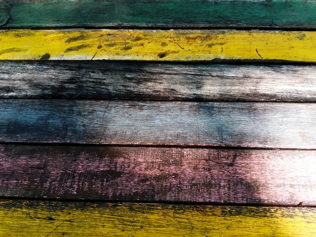 Dirty Colorful (Yellow, Black, Green, Pink and White) wooden table with light.