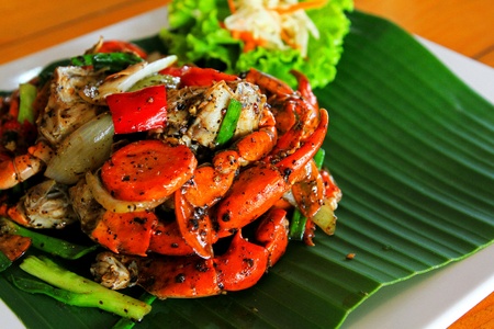 Red Fried crab with black pepper on the banana leaf and white plate by selected focus with copy space - Still life and Thai foodの写真素材