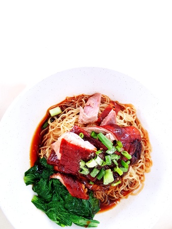 Duck roasted with noodle soup, vegetable and green onion chopped on the white bowl isolated on white...