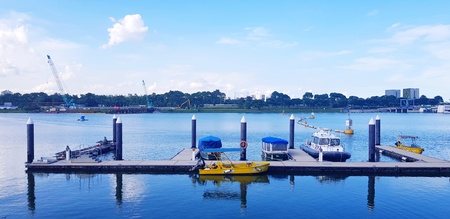 Singapore, Singapore - June 29, 2018: Many boats are parked at the port of Singapore near the Marina Barrage with clear sky and white cloud for background - Transport and Shipping conceptのeditorial素材
