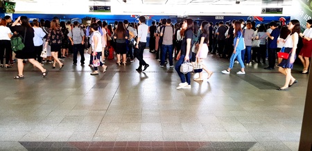 Singapore, Singapore - June 28, 2018: Many people walking, running and waiting on subway train...