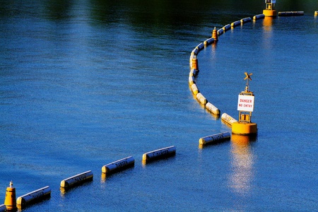 Yellow buoy and line danger area floating and warning boat and ship sailing on the sea this restricted area - Object, Sign, Alert, Protective and Safety zone conceptの写真素材