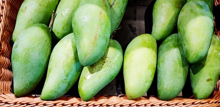 Fresh organic mango on brown weave basket for sale at supermarket - Food and Asian Fruit conceptの写真素材