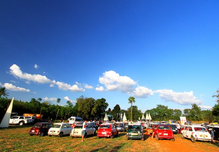 Nakhonratchasima, Thailand - December 16, 2017: Many old Classic Mini Austin cooper parked on grass field with green tree and clear blue sky background at Bonanza Khao Yai, Nakhonratchasima, Thailandのeditorial素材