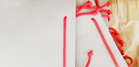 Gray paper bag with red rope putting on brown paper for container gift or present with copy spaceの写真素材