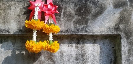 Beautiful garland hanging on the dirty rough concrete wall background with copy space - Beautiful,...