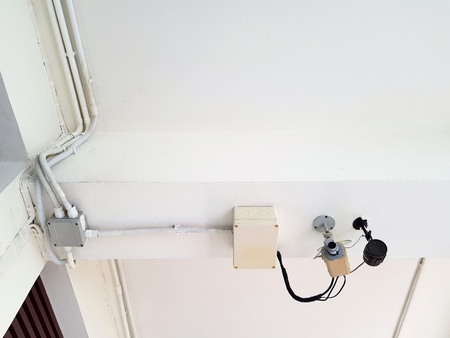 Security camera, surveillance camera or CCTV (Close Circuit Television) installed on white ceiling...