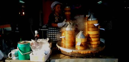 Hat Yai, Thailand - January 22, 2019: The Asian seller cooking and selling steamed dim sum with...