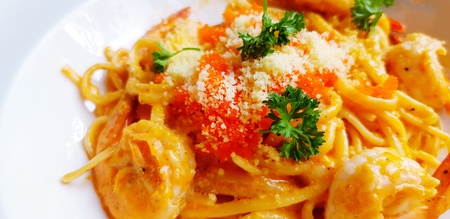 Shrimp paste pasta or spaghetti with cheese, Shrimp egg and herb on top in white plate - Selective focus and Italian food conceptの写真素材