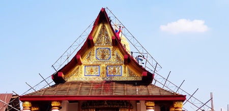 Construction workers are repairing the roof of ancient temple and clear blue sky background with copy space at Wat Phra Sri Rattana Mahatat Woramahawihan or Wat Yai temple in Phitsanulok, Thailandの写真素材