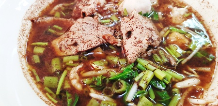 Close up hot noodle with thicken soup, fresh liver and sliced Chinese morning glory - Thai noodle...