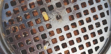 Top view of Cigarette stub in stainless steel or aluminum ashtray - Smoking area, Unhealthy and Not good for health conceptの写真素材
