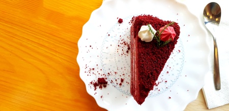 Flat lay or top view of Raspberry red velvet cake with Lemon cream cheese frosting and spoon in white plate on wooden table with copy space - Sweet dessert, Delicious and CafÃ© time conceptの写真素材