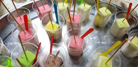 Close up colorful ancient ice cream in plastic glass on stainless steel tray for sale customer and serving - Original ice cream of Thai people in the many past year and Asian dessert conceptの写真素材